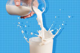 Milk from a jug pouring into glass on a blue background