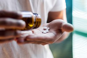 a photo of someone pouring folate pills into their hand