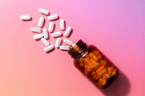 a photo of a bottle of supplements pouring out onto a pink, orange, and purple gradient