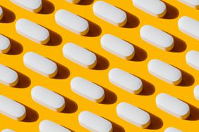 a photo of a vitamin capsule photographed on a yellow background